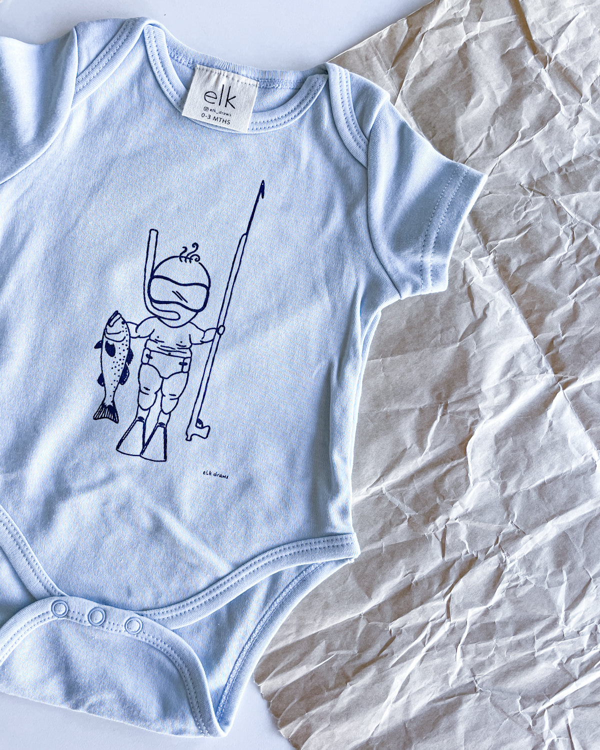 Baby blue organic cotton onesie with baby spearo on it.