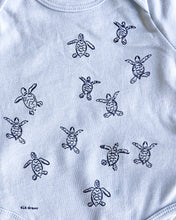 Load image into Gallery viewer, Baby blue organic cotton onesie with turtle hatchlings on it.