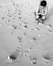Load image into Gallery viewer, Girl on beach wearing elk draws cap watching turtle hatchling