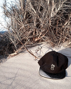 Squid Ink black coffee pot cap by elk draws sitting on sand