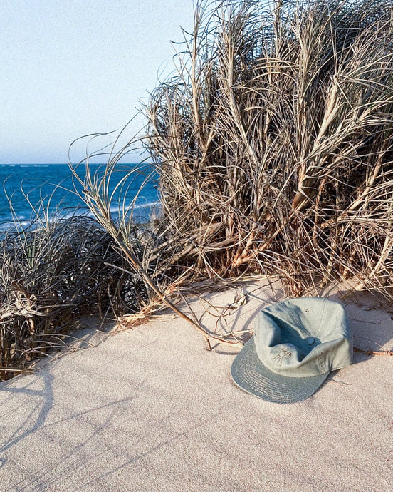 Eucalyptus colour elk draws cap with coffee pot design sitting on sand
