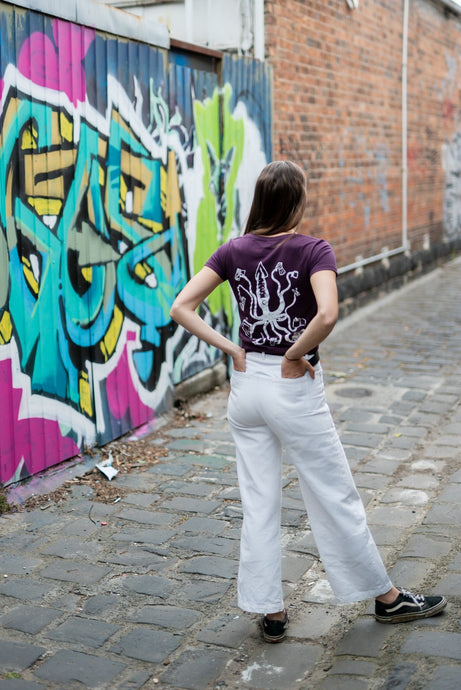 woman in city wearing tshirt with squid on the rear