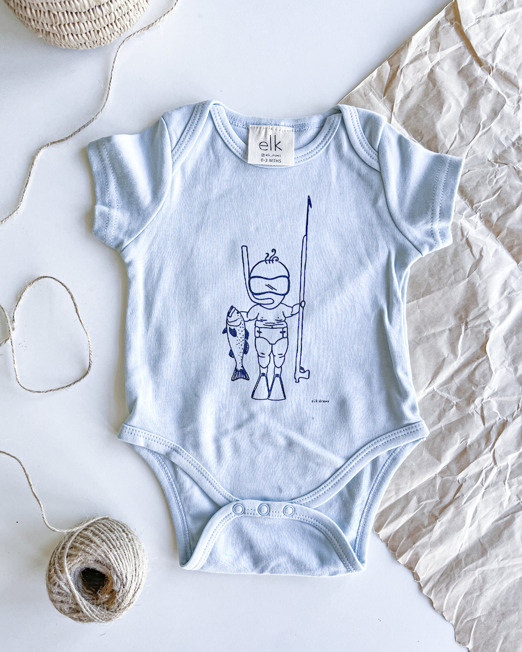 Baby blue organic cotton onesie with baby spearo on it.