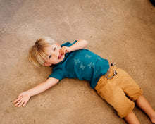 Load image into Gallery viewer, Young boy wearing blue organic cotton tshirt with turtle hatchlings on it.