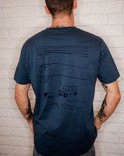 Load image into Gallery viewer, Male wearing Elk Draws blue organic cotton tshirt with troopy camping on it 