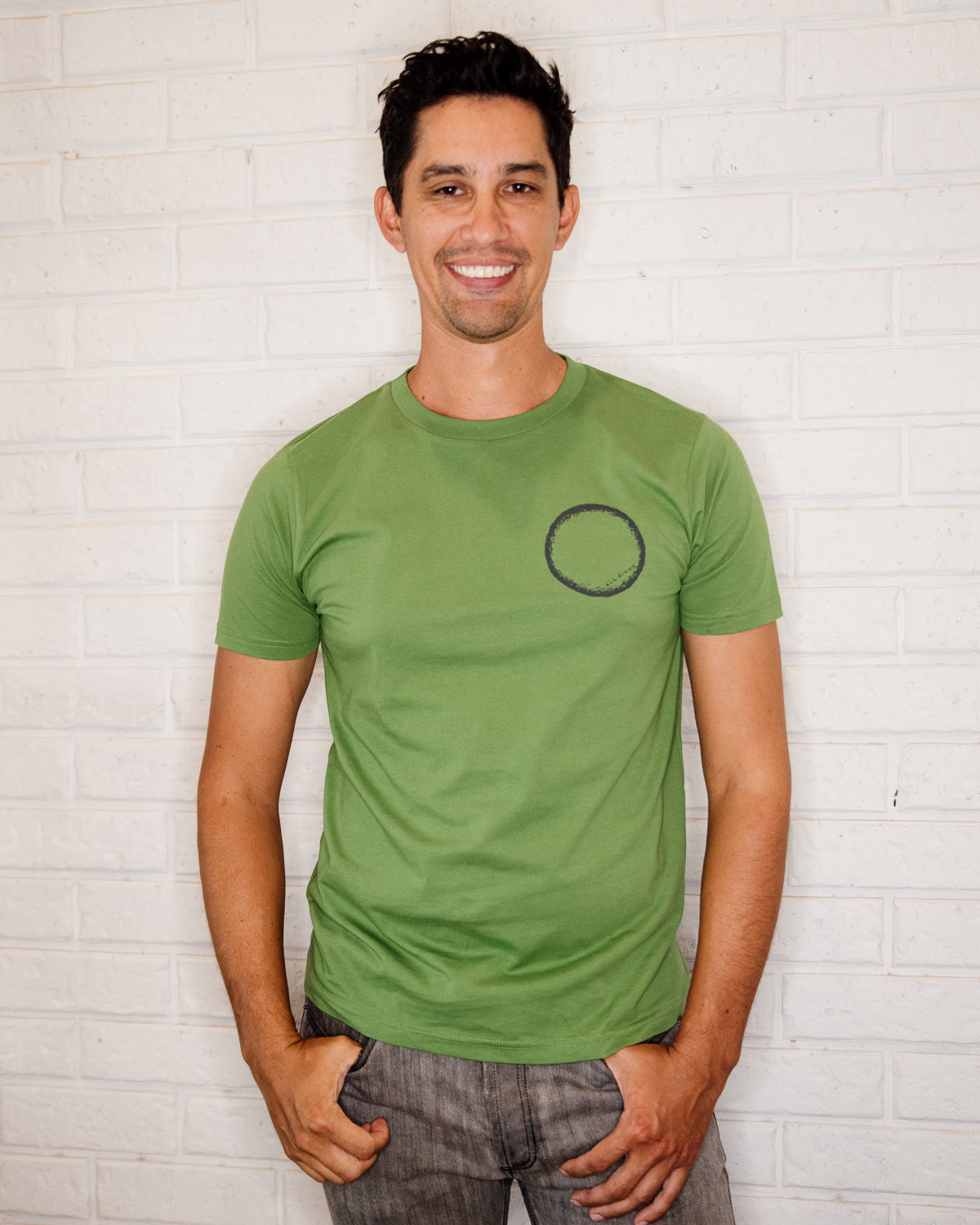 Male wearing elk draws green organic cotton tshirt wih circle on it.