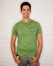 Load image into Gallery viewer, Male wearing elk draws green organic cotton tshirt wih circle on it.
