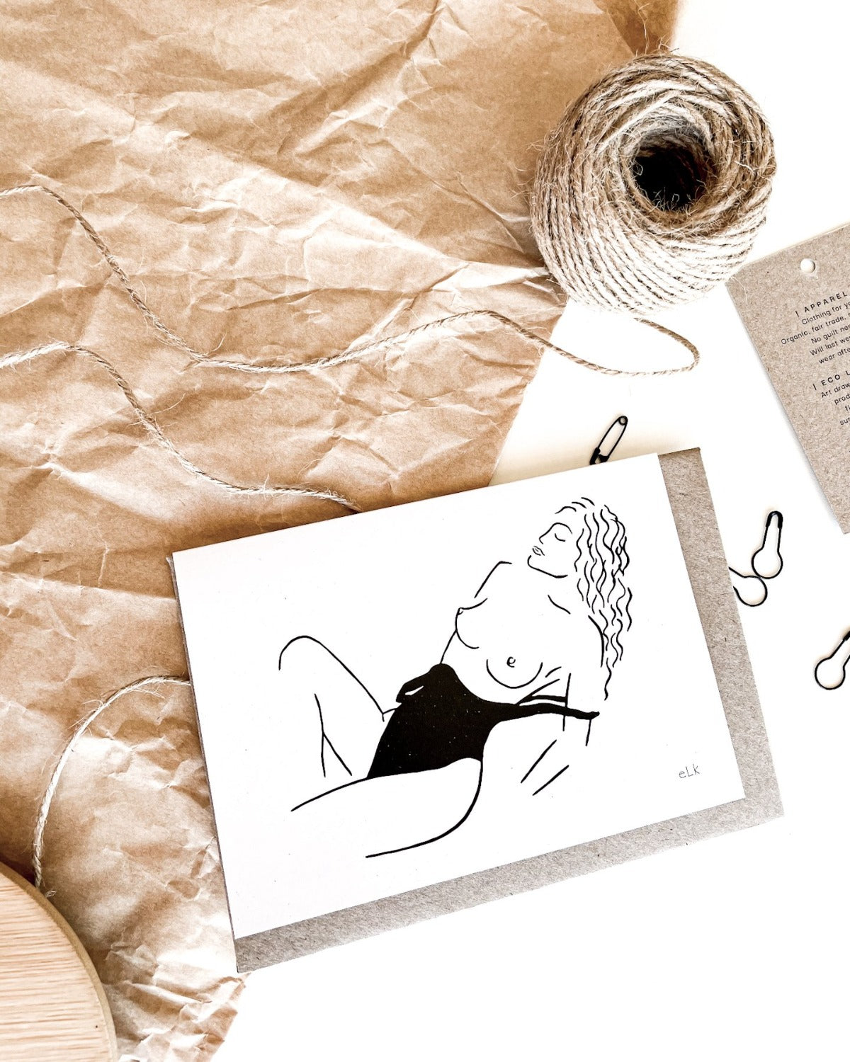 Line art of topless woman at beach in bathing suite on recycled eco friendly green greeting card.