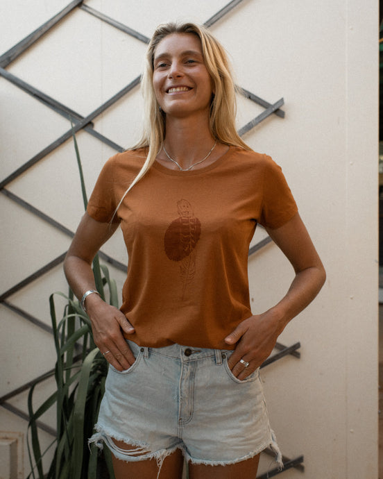 female wearing elk draws orange rust organic cotton tshirt.