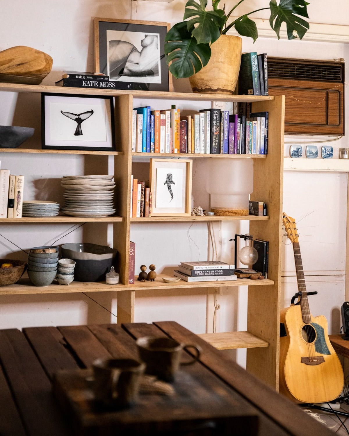 She print with whaleshark with humpback whale fluke print and guitar in open plan kitchen