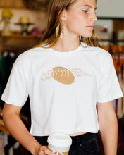 Load image into Gallery viewer, Female wearing elk draws white crop organic cotton tshirt with feather on it.