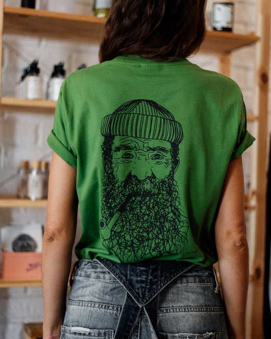 Female wearing elk draws green organic cotton tshirt with a Fisherman on it.