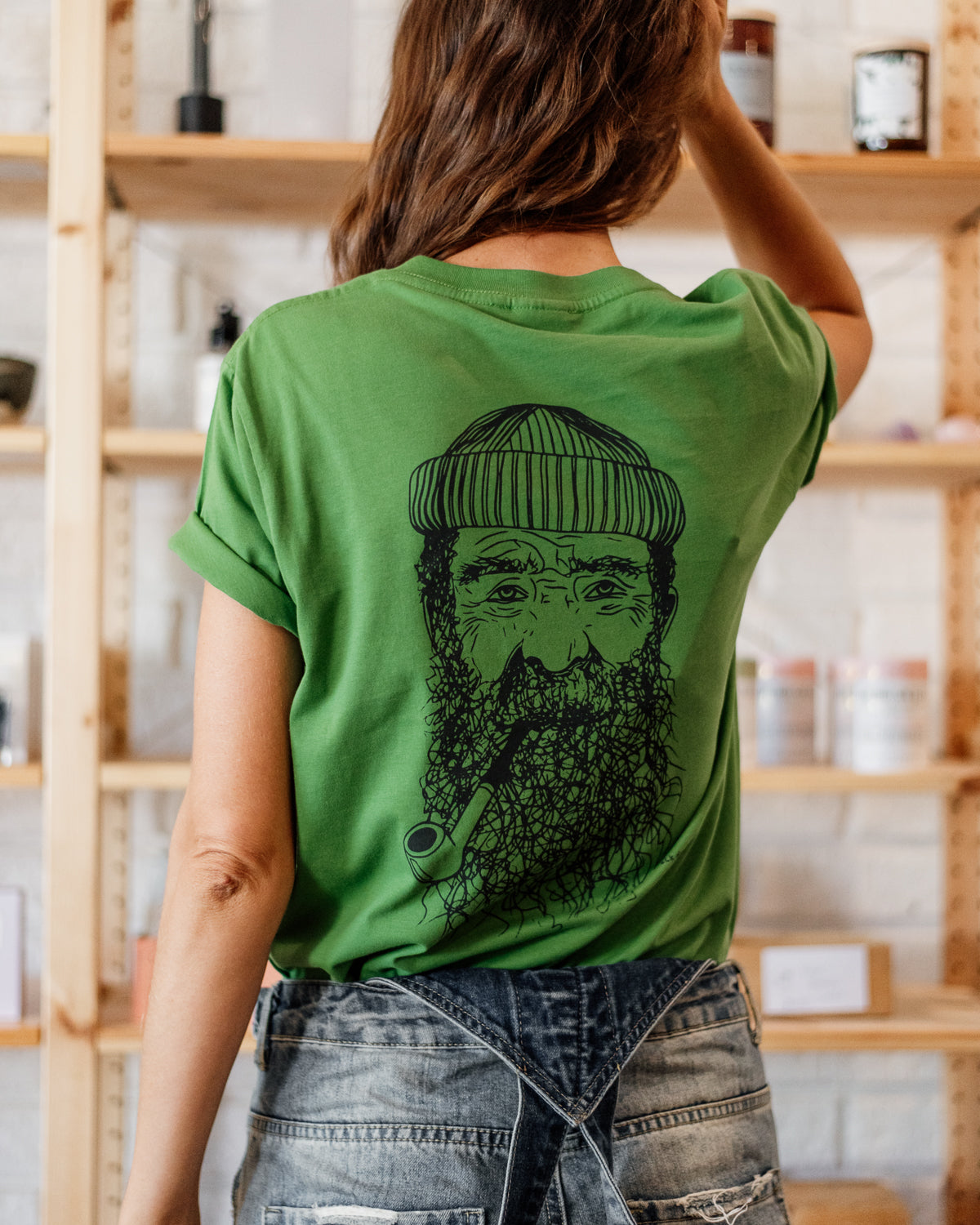 Female wearing elk draws green organic cotton tshirt with a Fisherman on it.