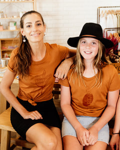 Two females wearing elk draws organic cotton tshirts
